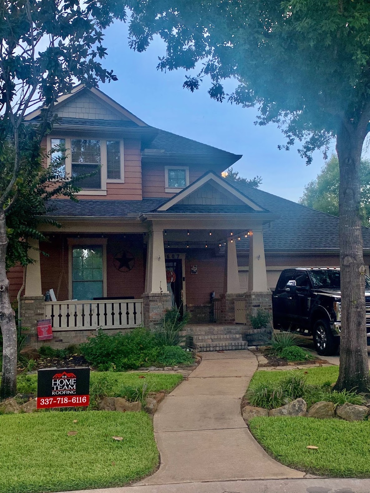 Completed dark shingle roof on craftsman-style residential home