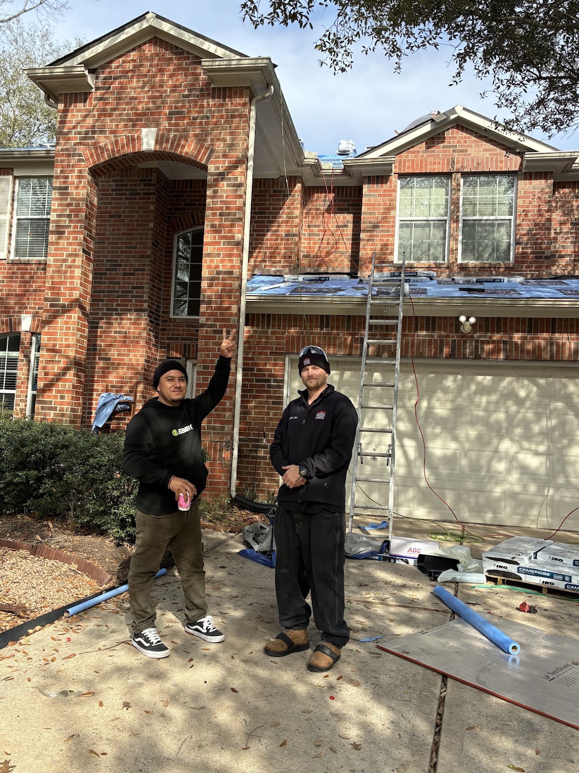 Home Team roofing crew at active residential roof installation